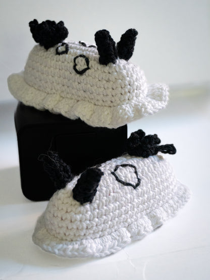 Crocheted black and white cat costume on a white background
